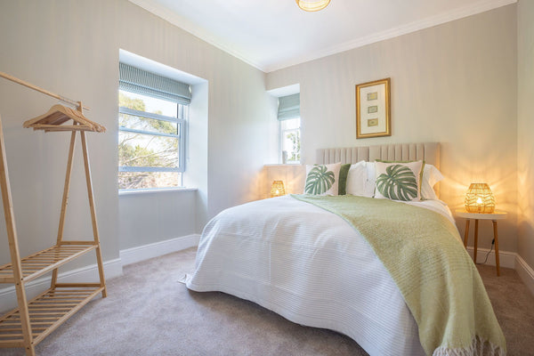 A bedroom at Bron Menai with a large bed and garden views